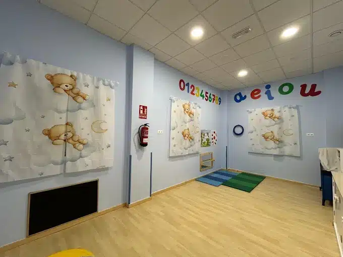 Aula de bebés de 0 a 1 años en CEI Caracola con zona de juegos y descanso.